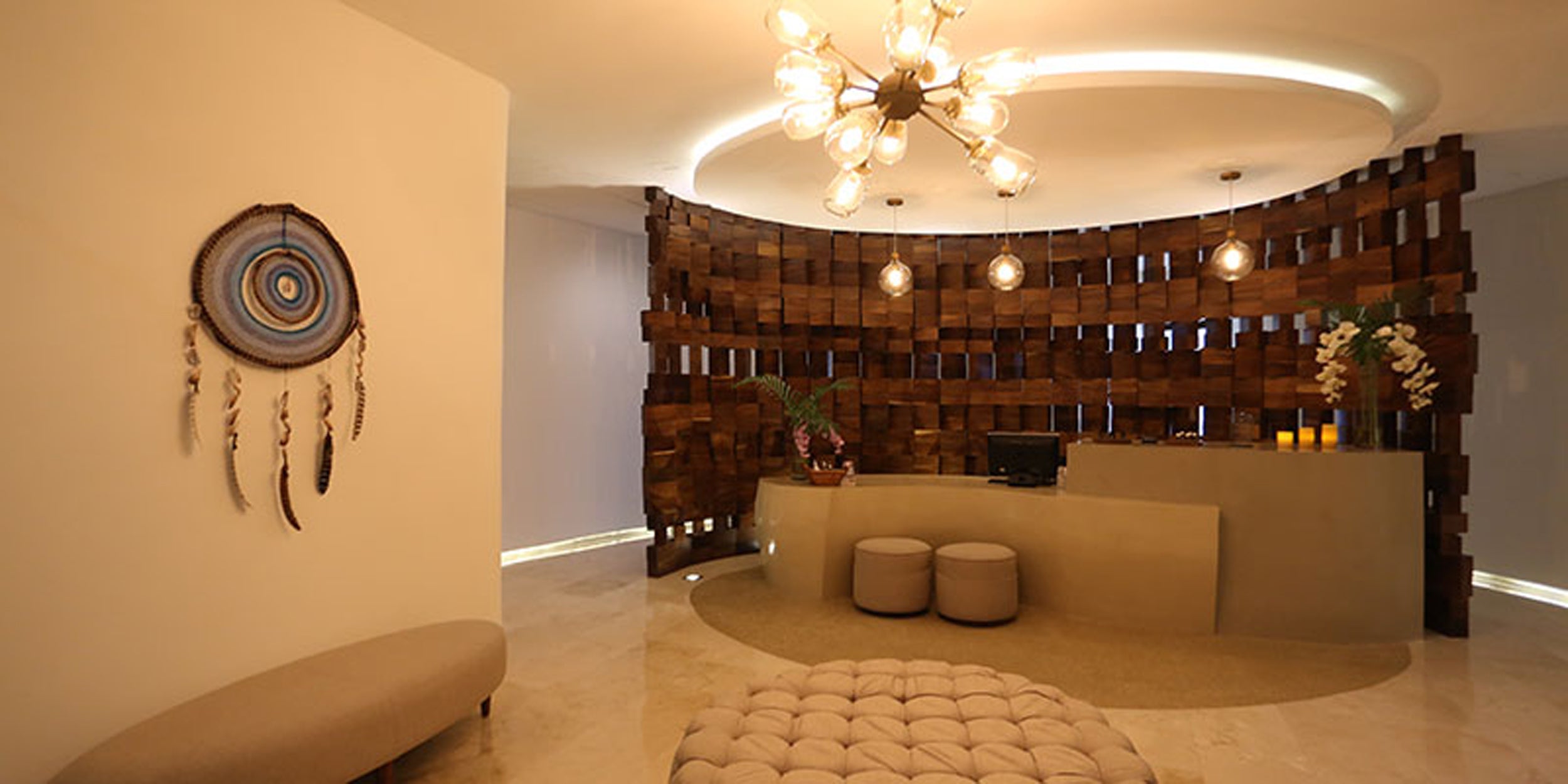 Modern interior design with a wooden wall feature, chandelier, and decorative elements.