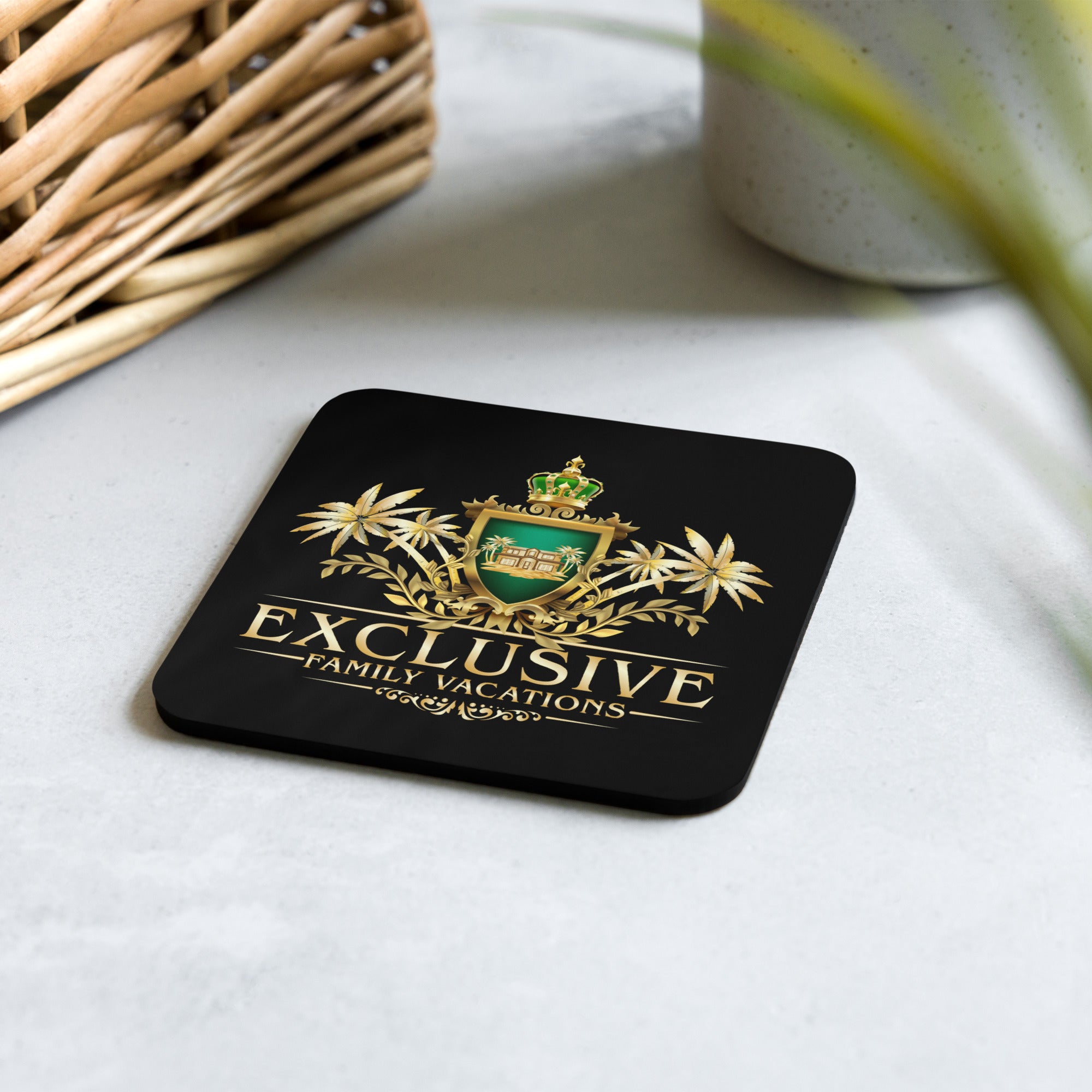 Black coaster with gold and green design and 'Exclusive Family Vacations' logo on a light surface.