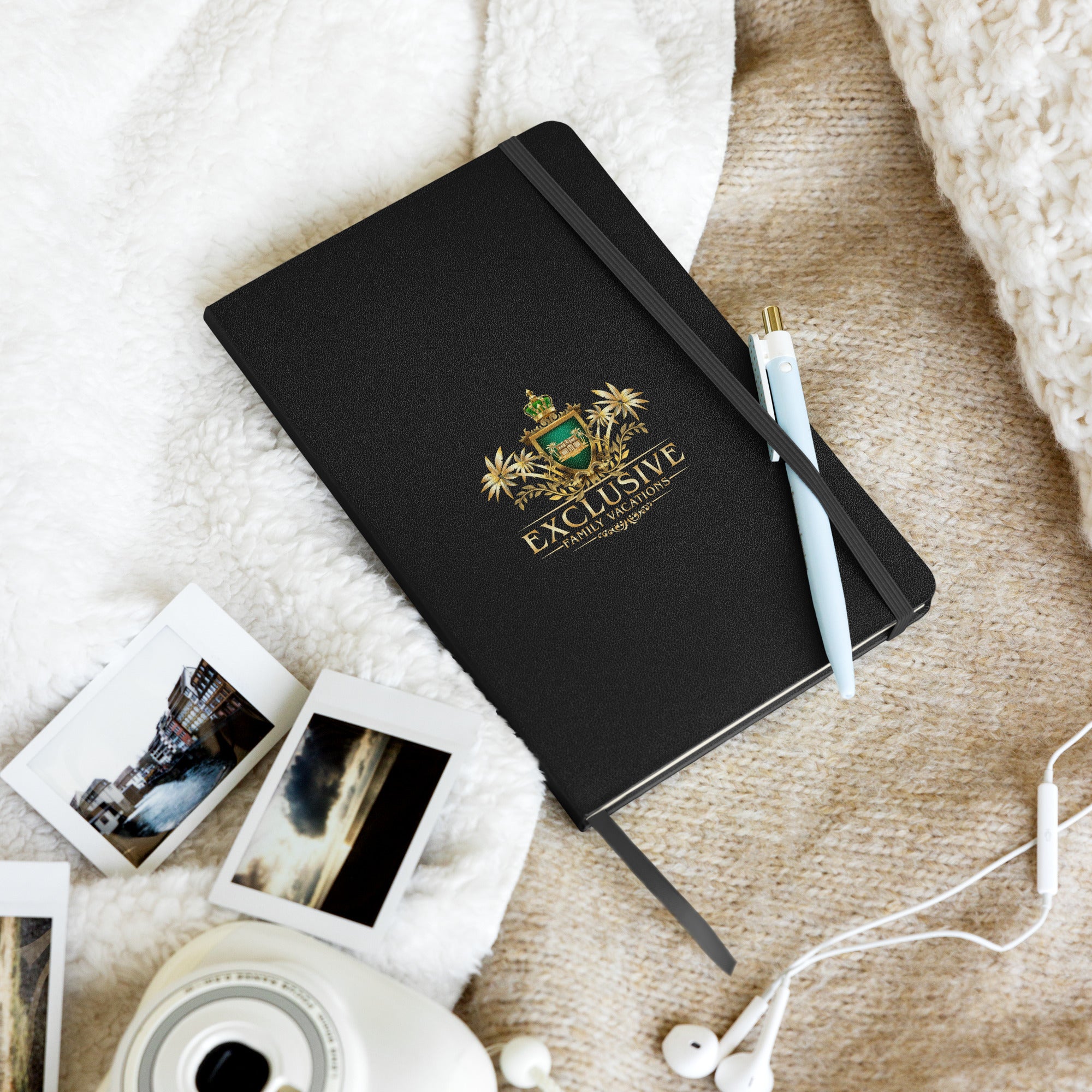 Black journal with a logo and text on a textured surface with photos and earphones.