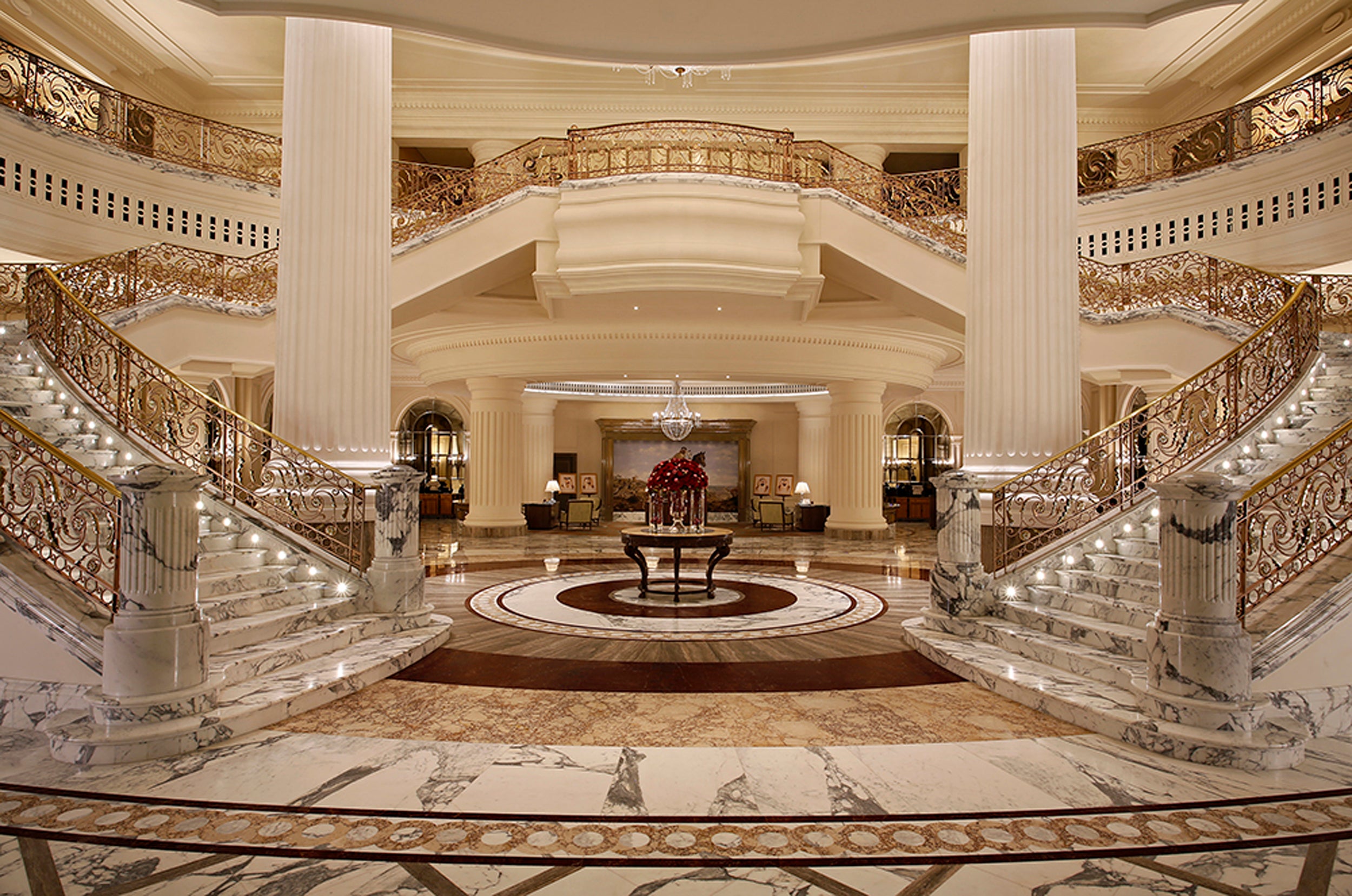 Luxurious interior of a grand building with marble staircase and decorative elements.