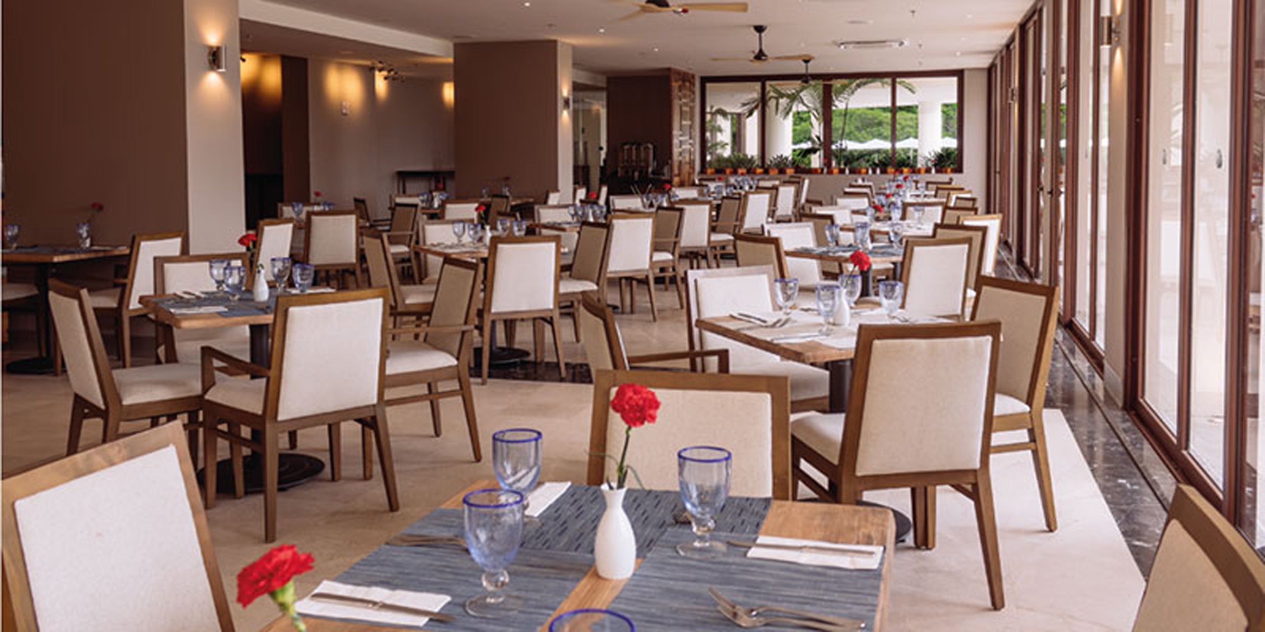 Modern restaurant interior with tables set for dining.