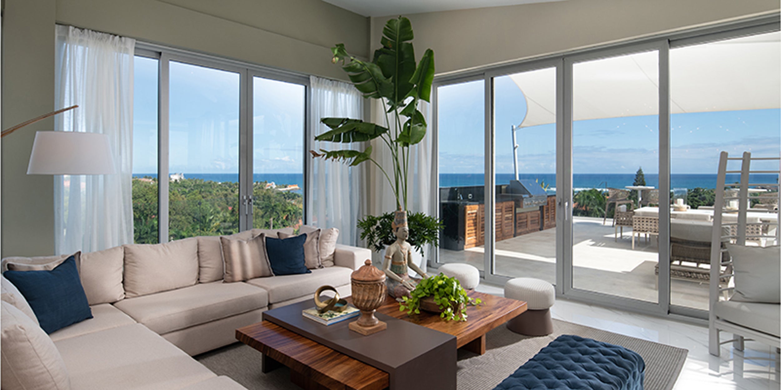 Modern living room with large windows overlooking a scenic view.