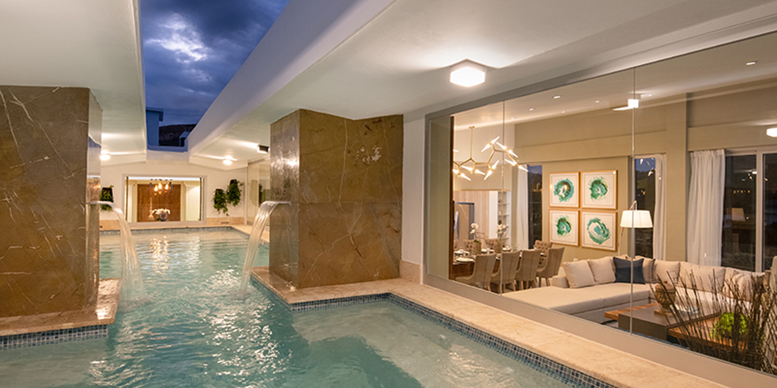 Luxurious indoor pool area with modern decor and seating