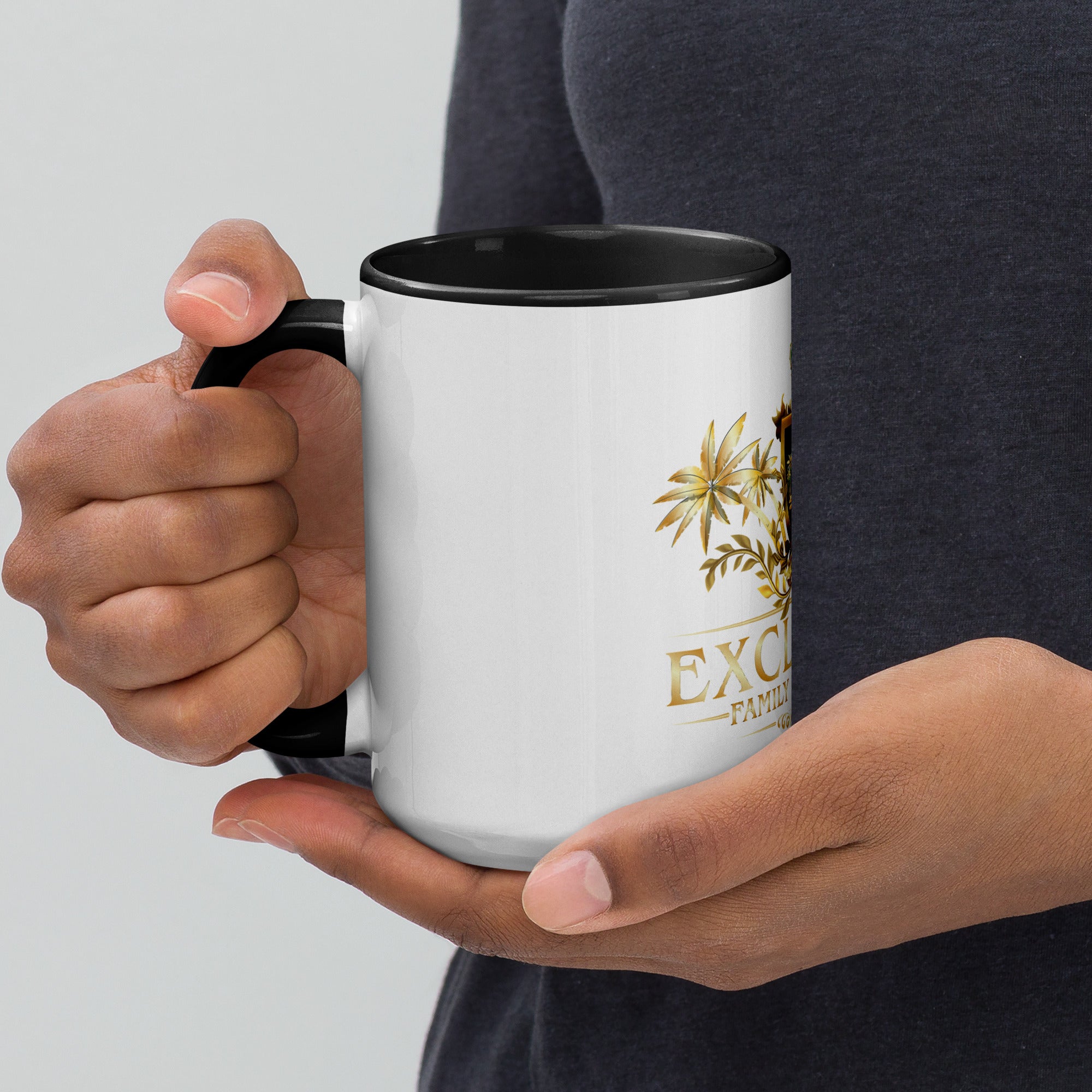 Person holding a white mug with black interior, featuring a logo and text.