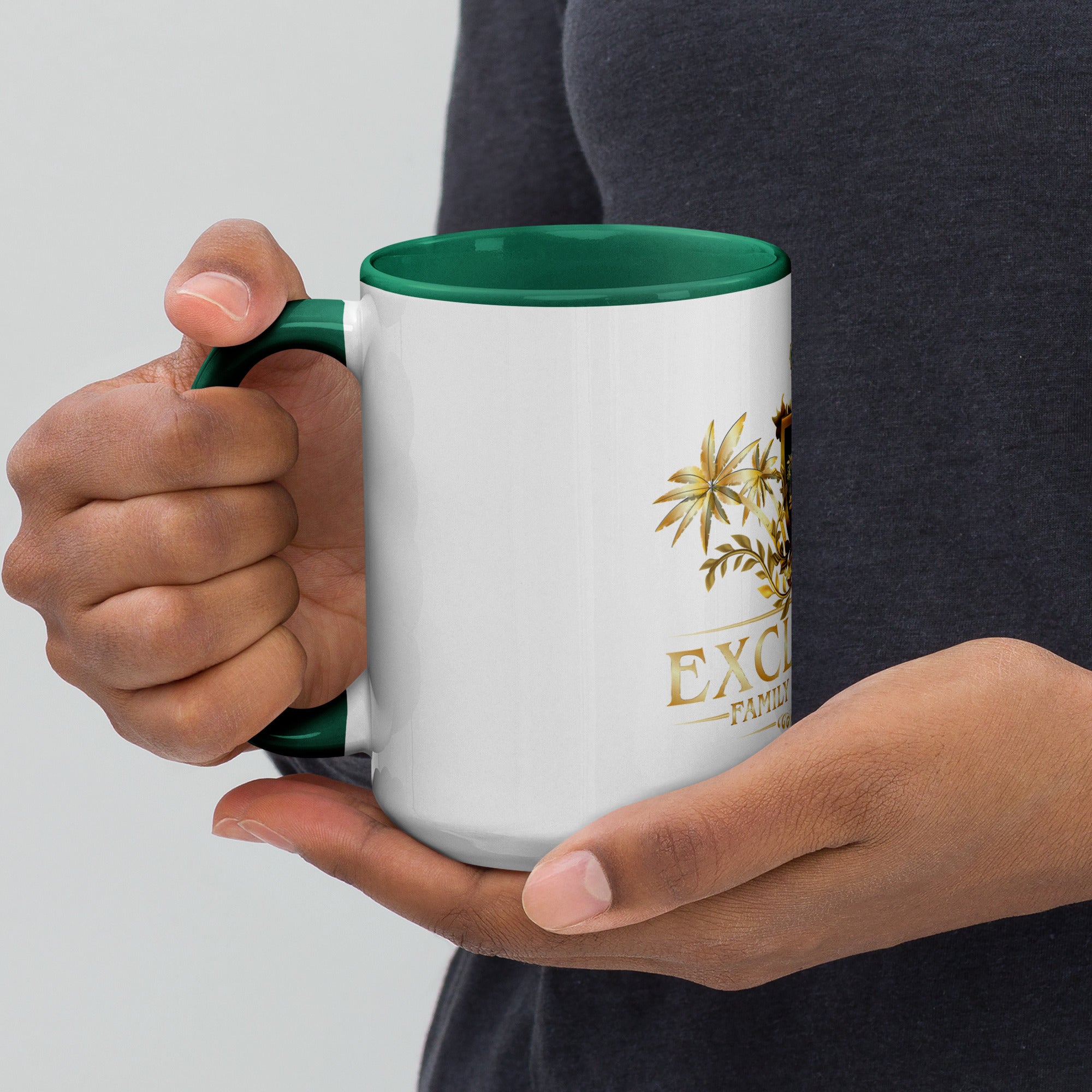 Person holding a white mug with green interior and handle, featuring a logo and text.